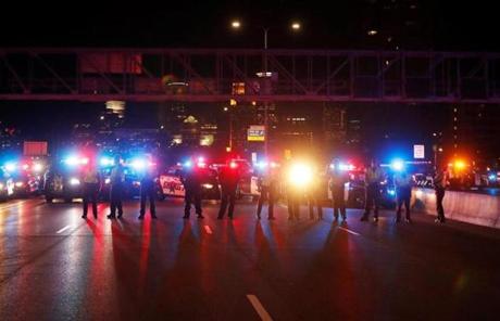 Police kept watch as demonstrators protested against President-elect Donald Trump in Minneapolis.
